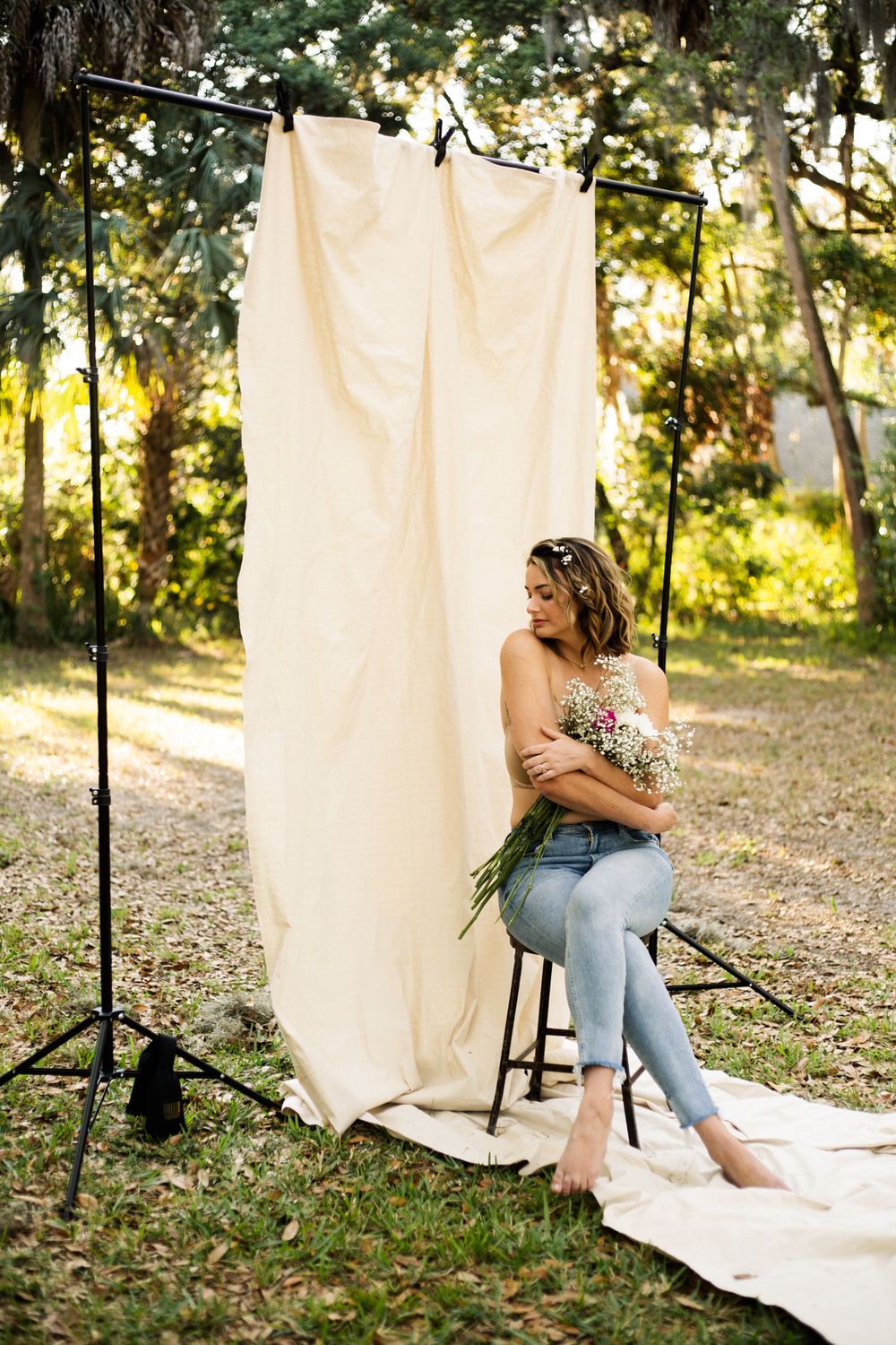 Artistic outdoor photo with cream backdrop and natural lighting in woodland setting.