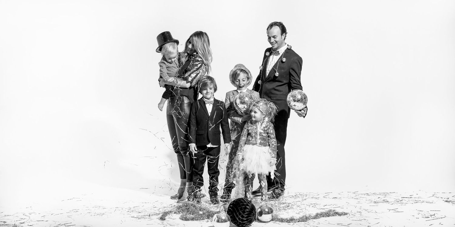 Black and white vintage family portrait on beach.