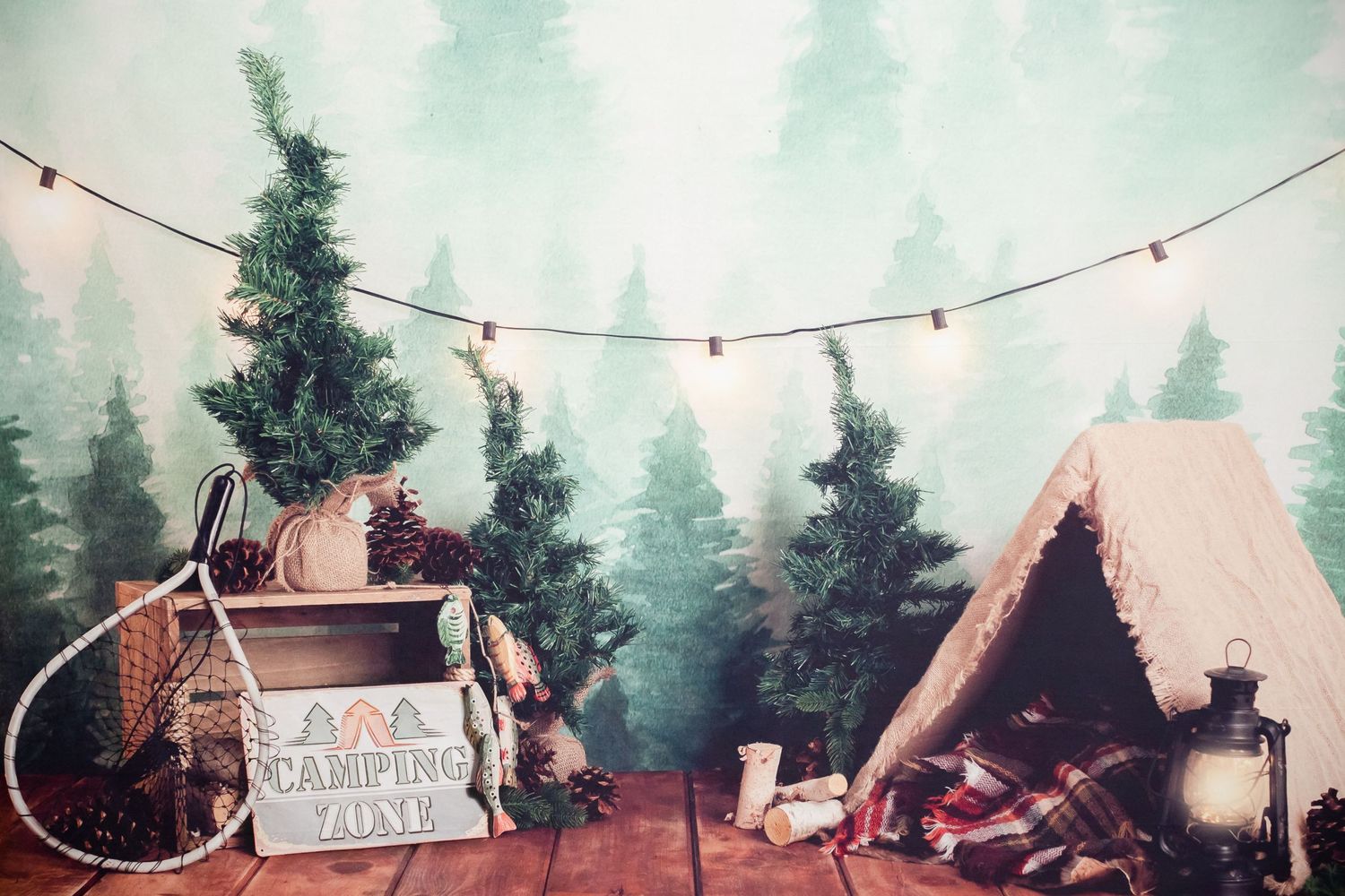 Cozy winter scene with Christmas trees, string lights, and rustic wooden tent setup.