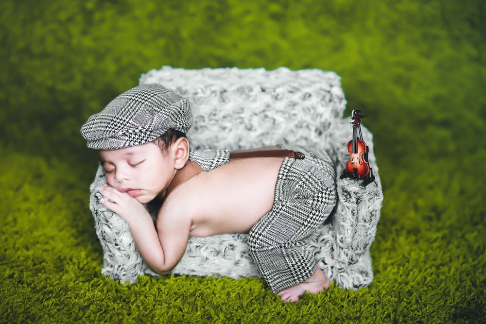 3 months old baby boy sleeping on a miniature sofa, creative thought by little vows