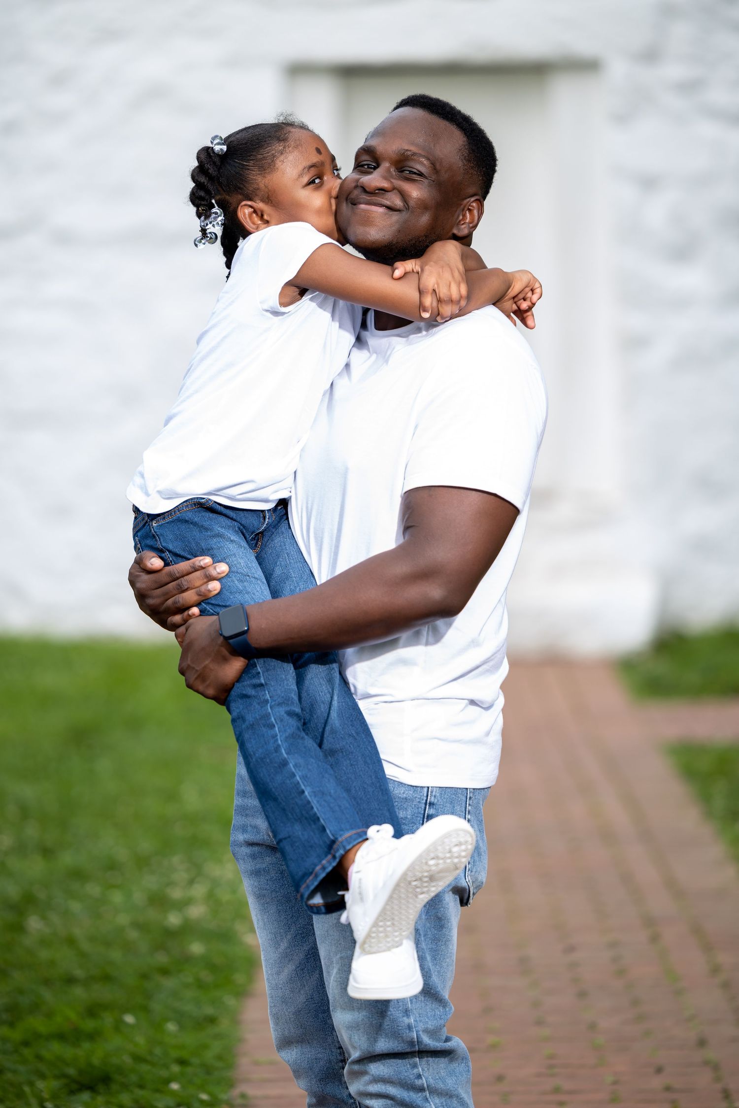 Joyful moment captured between parent and child embracing outdoors.