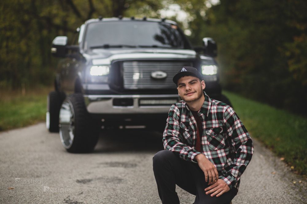 High school senior in front of his truck for his senior photography session.