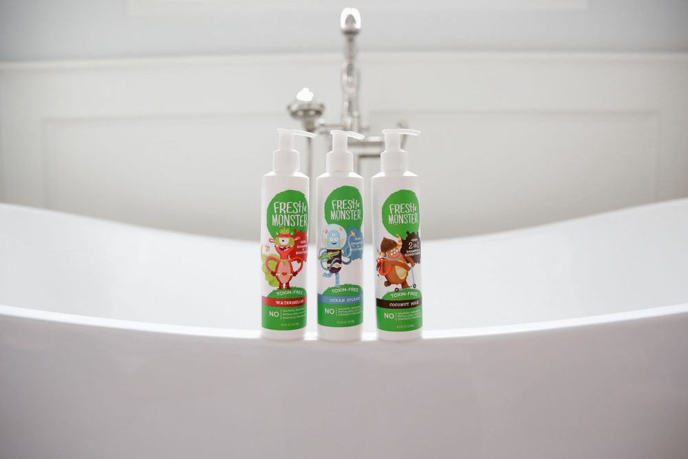 Three bottles of product on a bath ledge in natural light image