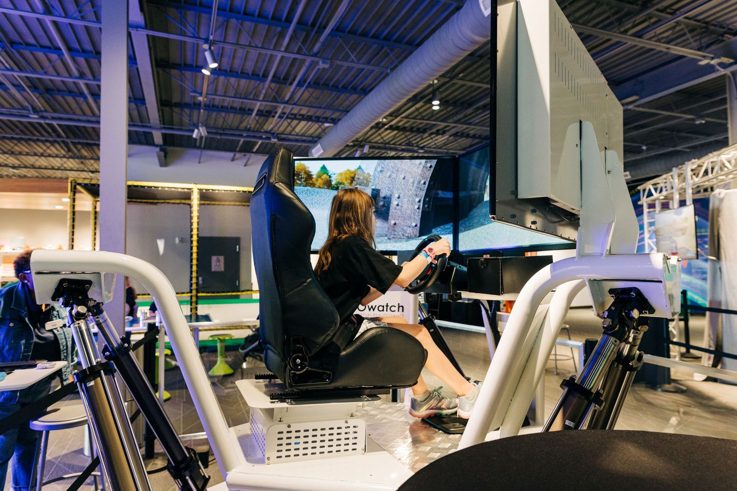 Girl playing VR racing game at Monroe Science Center