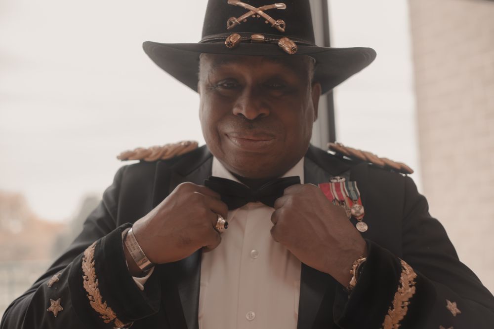 Military dress uniform with cavalry hat and medals.