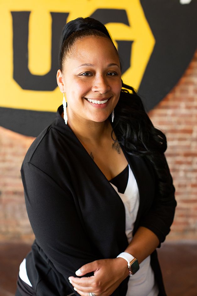 Woman in business attire headshot posing in downtown Augusta, GA.