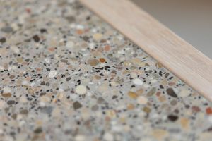 Close-up of terrazzo flooring showing multicolored stone aggregate pattern.
