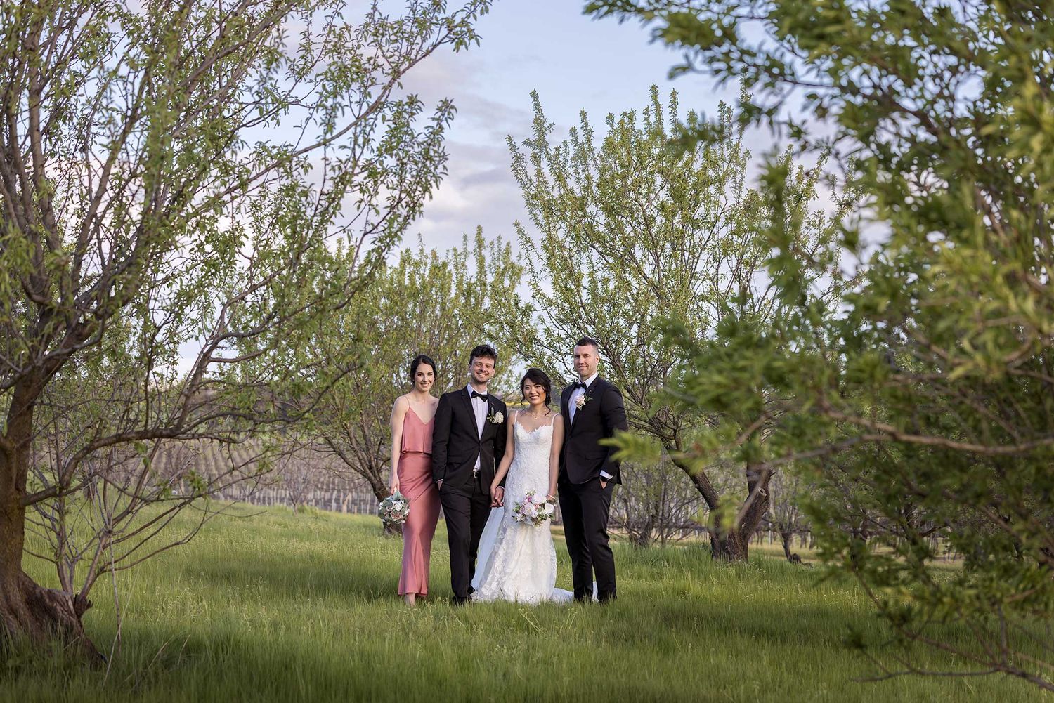 Bridal Party group shot standing in the orchard at De Bortoli Rutherglen Estate captured by Jason Robins