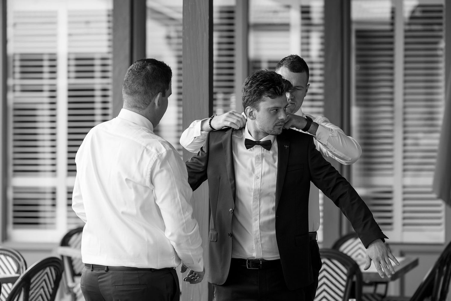 Groom and Groomsman putting on the grooms jacket at De Bortoli Rutherglen Estate