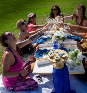 People gathered around a decorated outdoor table for a casual spring celebration.