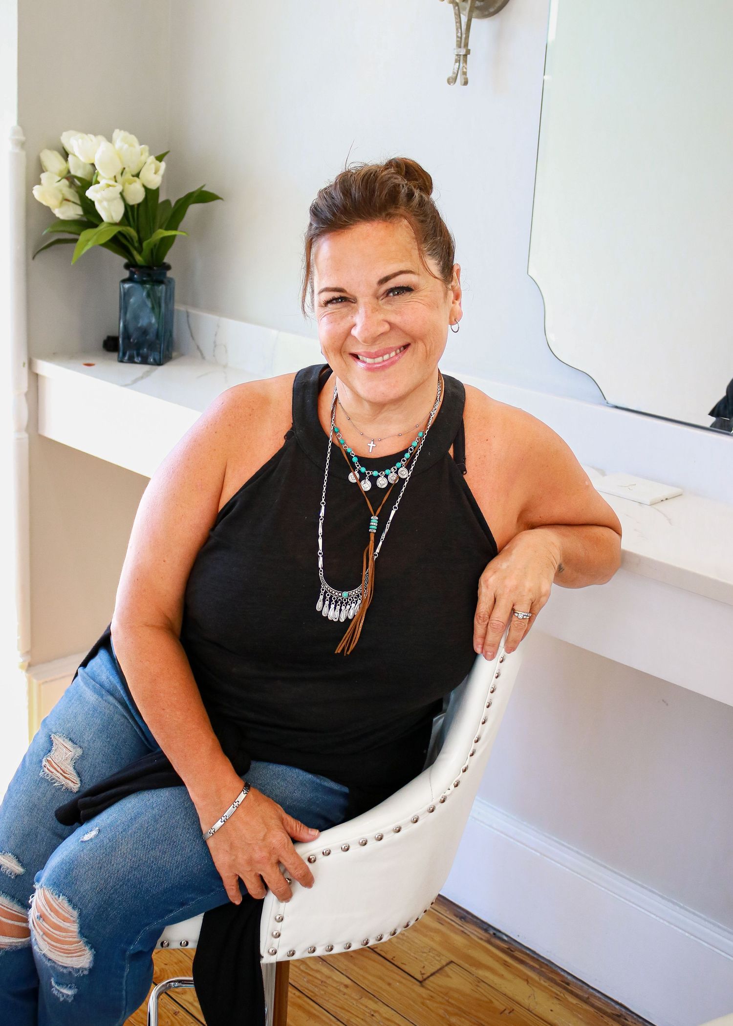 A casual portrait session in a white studio space with modern furnishings.