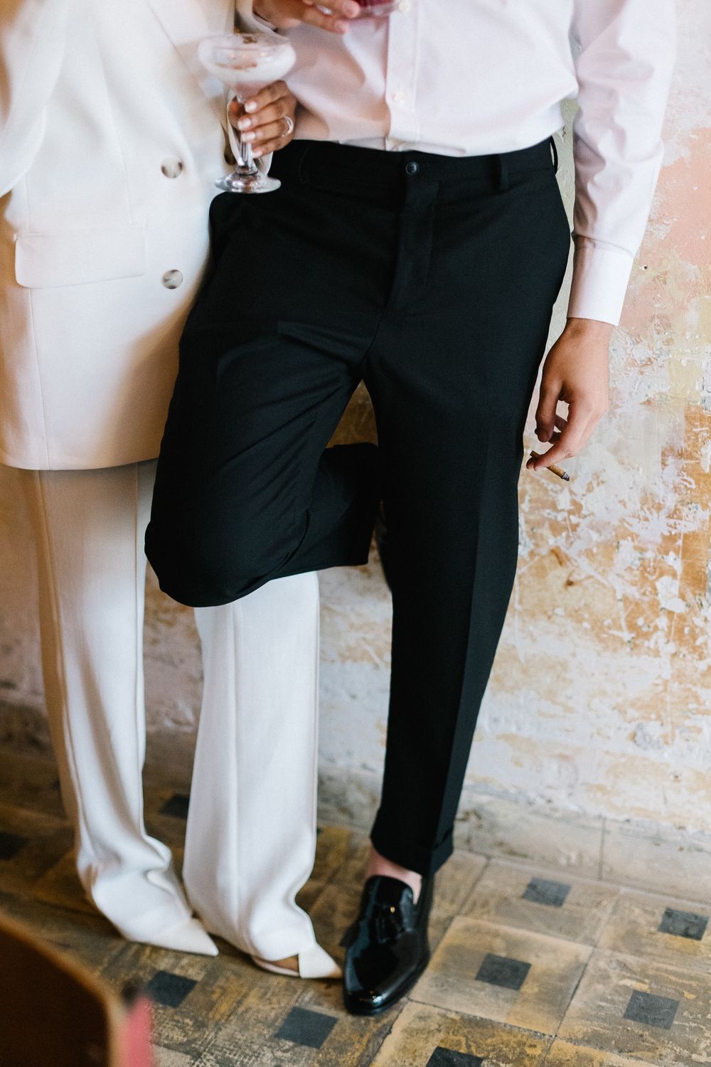 Fashion detail shot of couple in contrasting black and white formal wear.