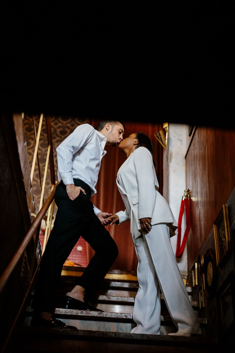 Romantic moment captured on vintage wooden staircase.