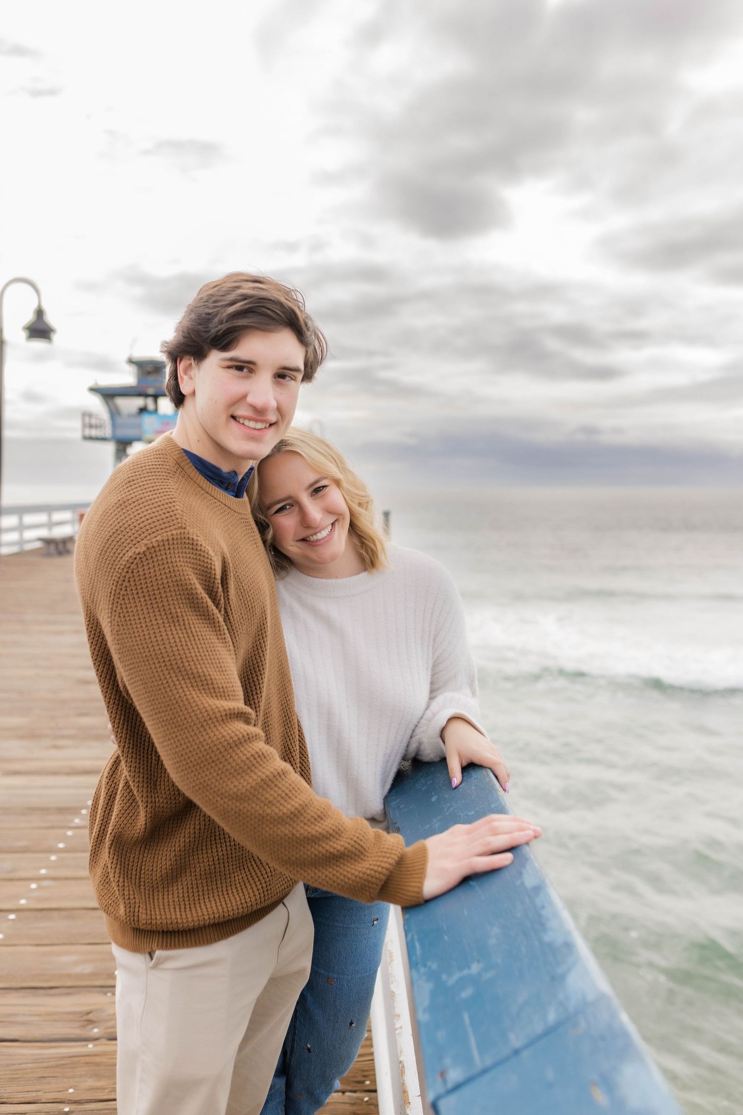 Boyfriend girlfriend on San Clemente Pier snuggly pose