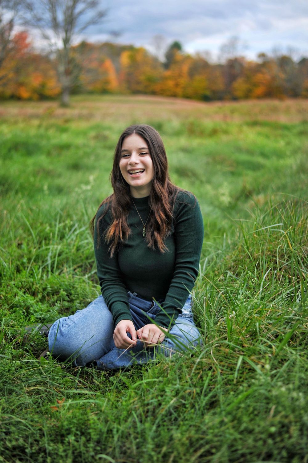 Girl laughing portrait fall foilage and grass