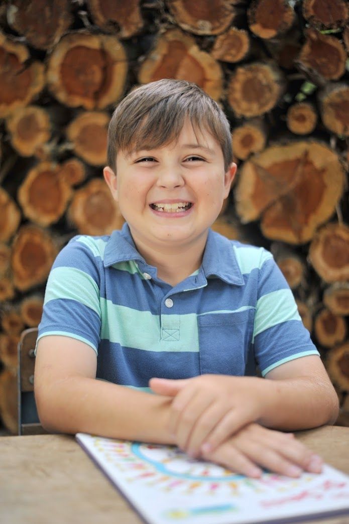 School age boy portrait at vintage school desk