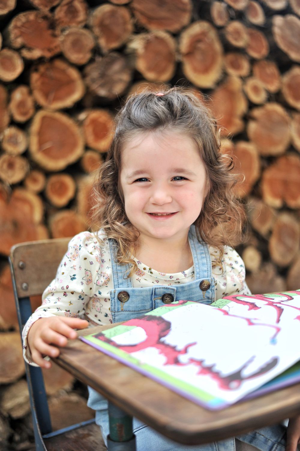 Girl portrait at vintage school desk at wood round wall
