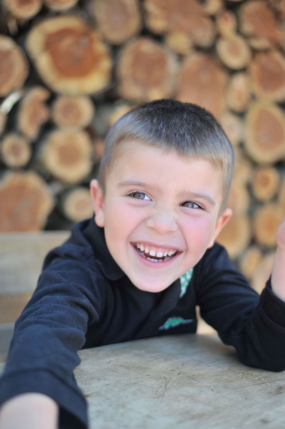 Boy laughing portrait at vintage school desk