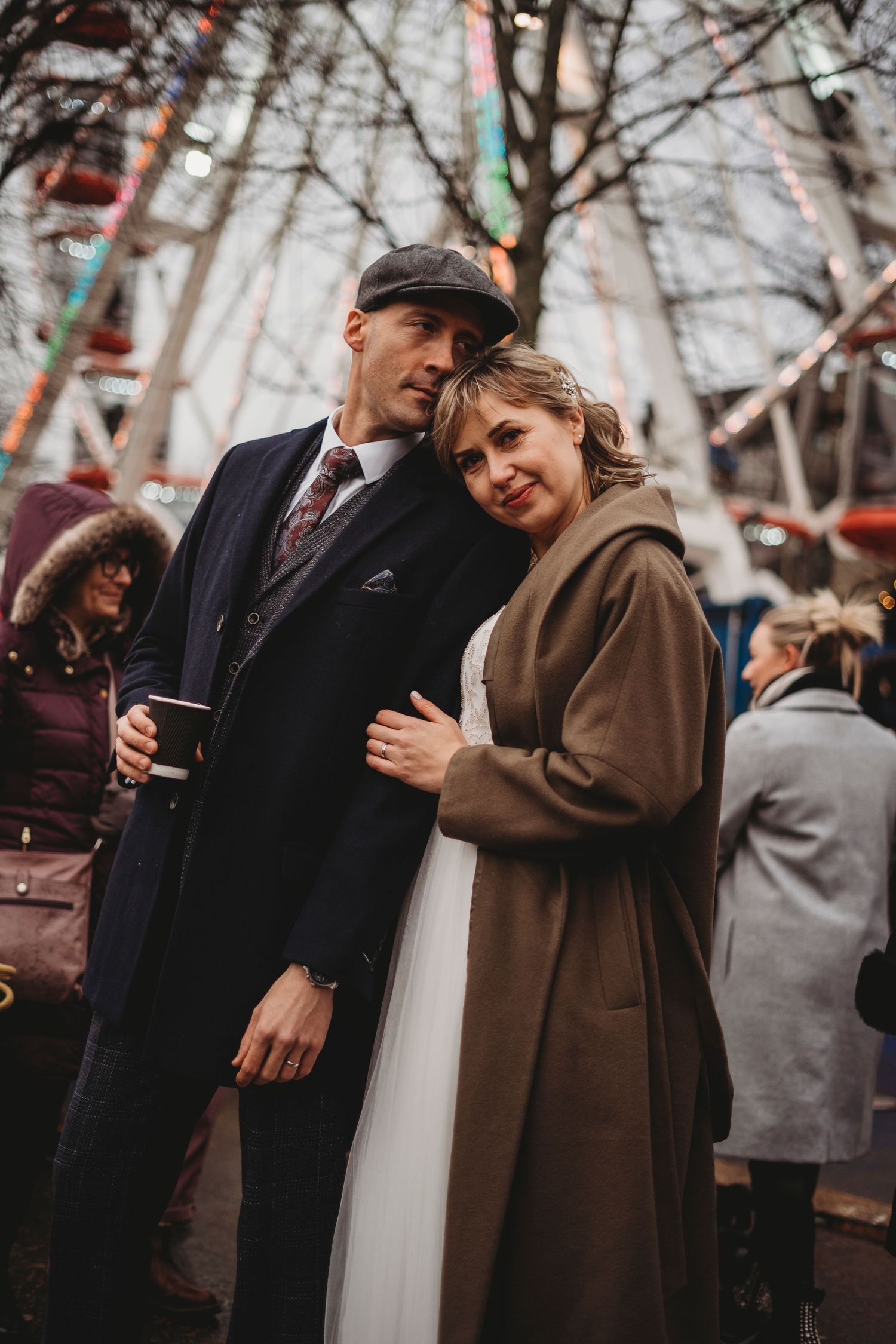 A cozy winter scene at a carnival with vintage-style outfits and decorations.
