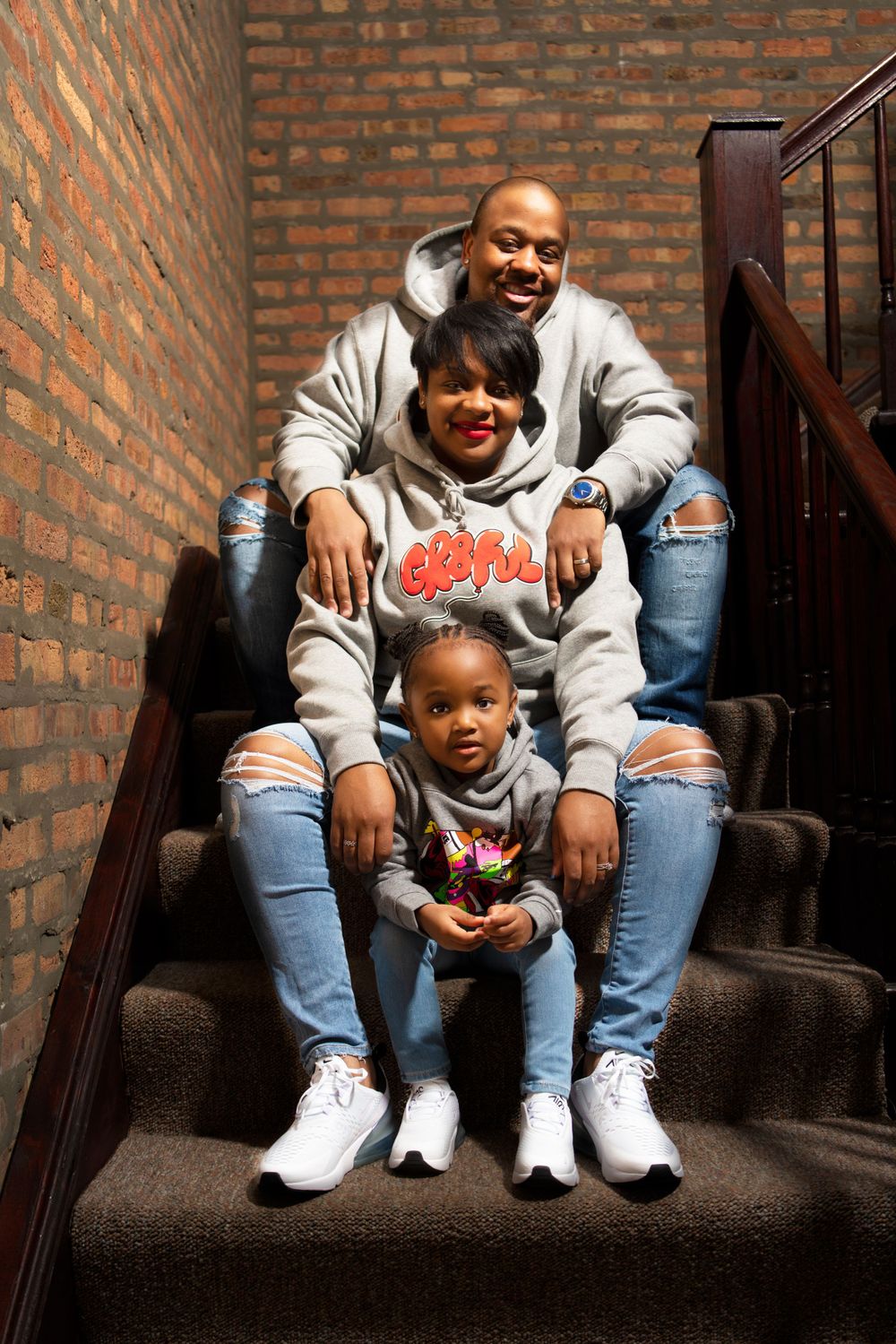 Casual lifestyle portrait on brick staircase with matching outfits.