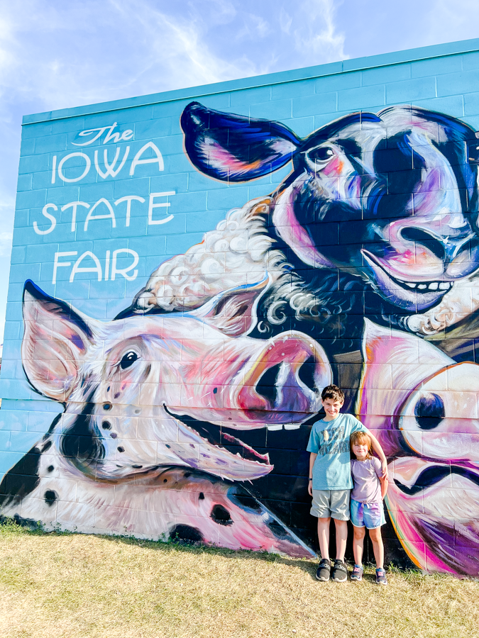 Colorful street art mural featuring whimsical animal characters painted on an outdoor wall.