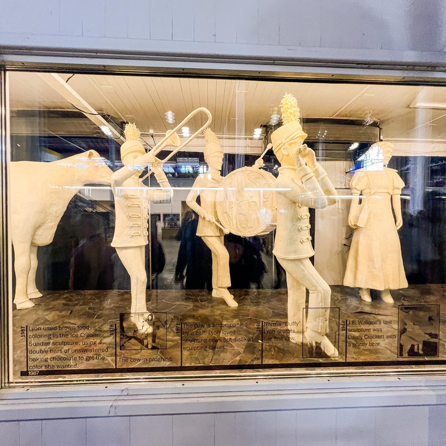 Window display featuring white silhouettes of musicians playing instruments in a retail storefront.