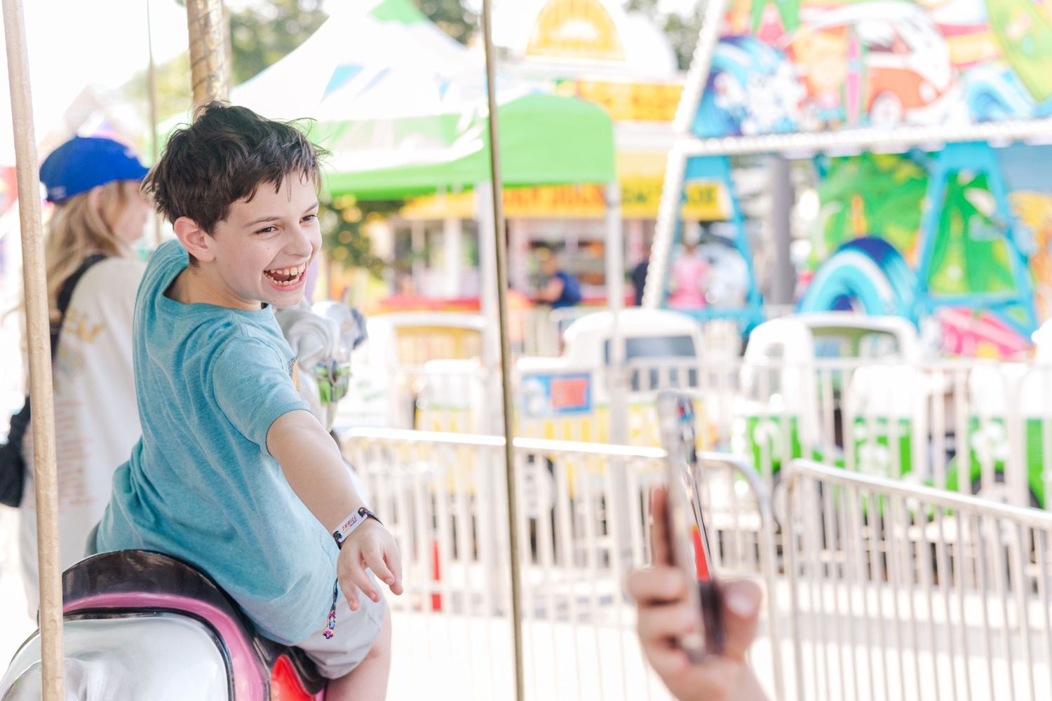 A joyful moment captured on a classic carousel ride at a carnival.