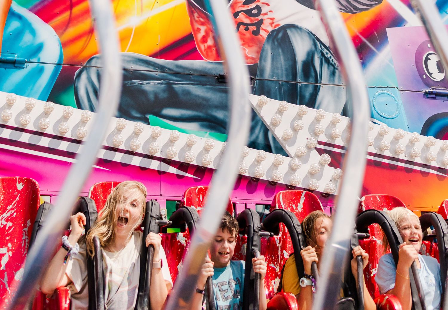 Close-up view of colorful carnival game prizes displayed behind protective barriers.