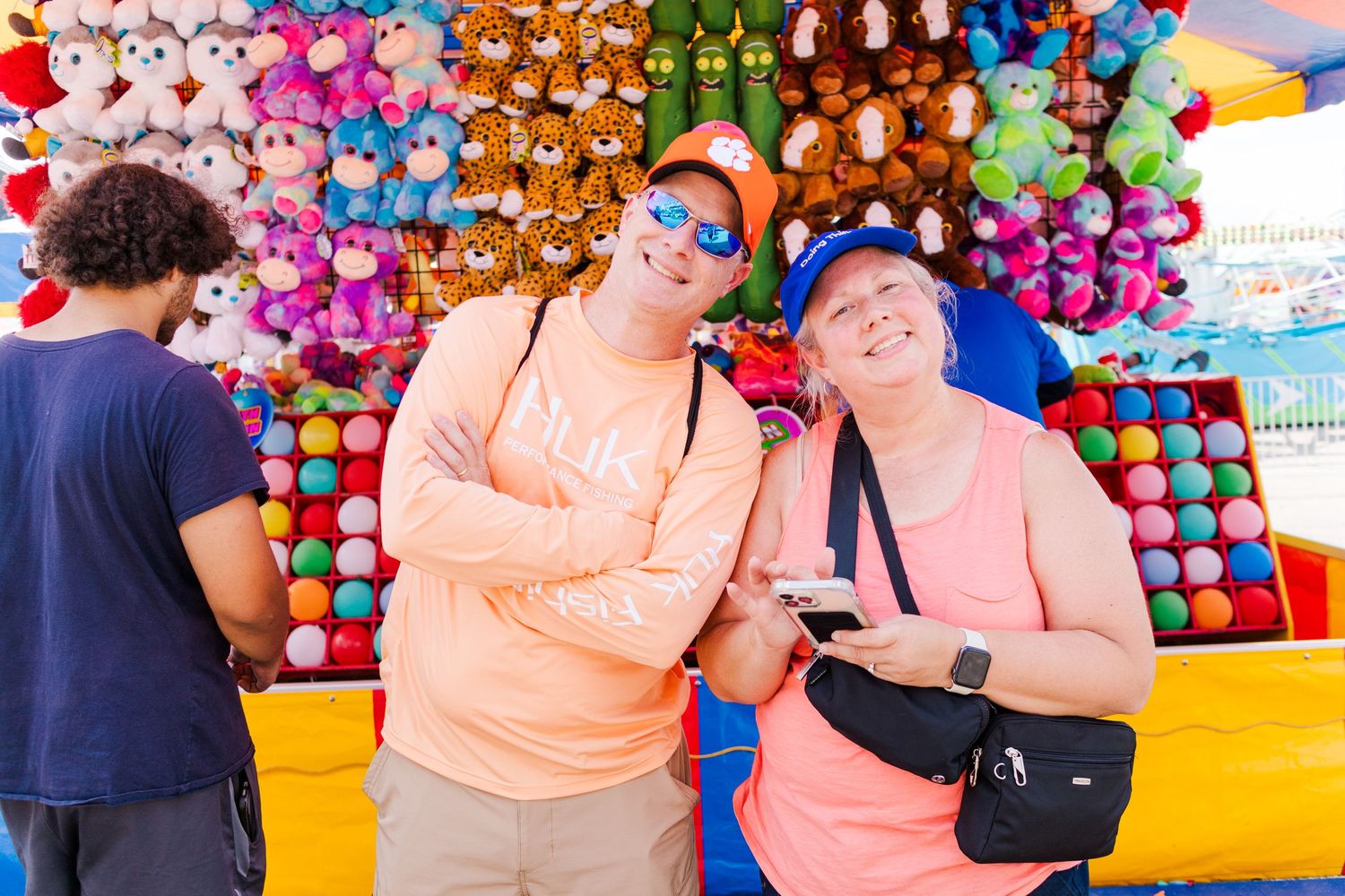 Rows of plush stuffed animals and carnival prizes on display at a fair game booth.