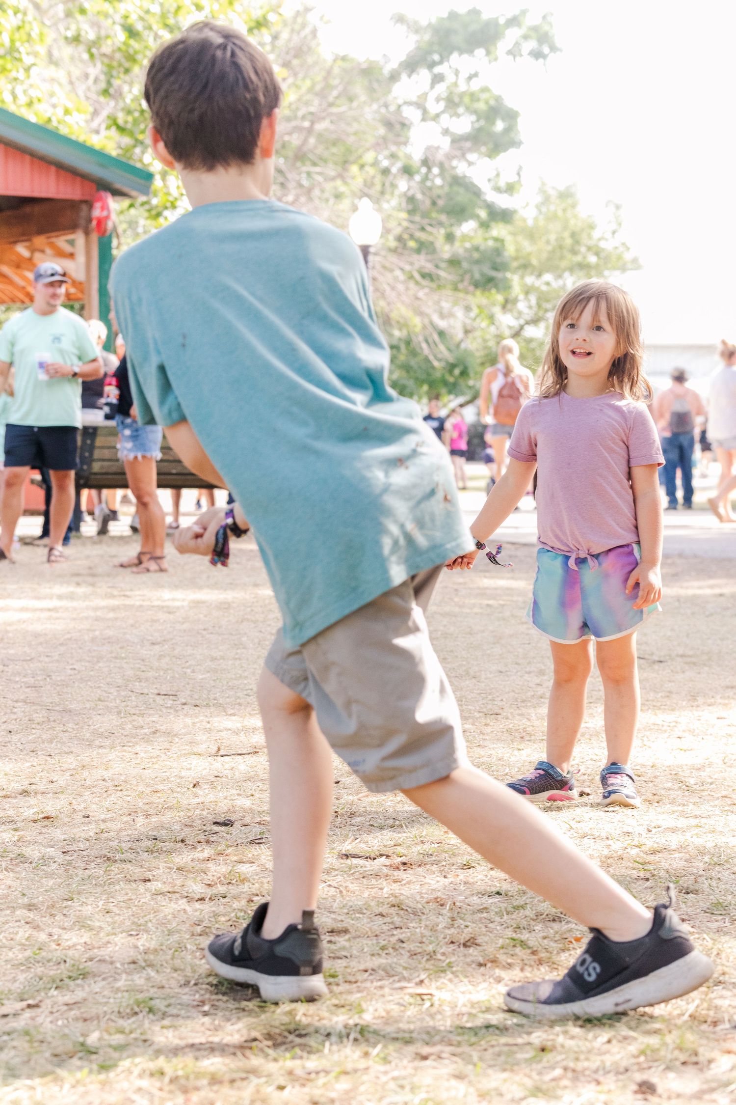 Children's feet in motion while playing at an outdoor carnival.