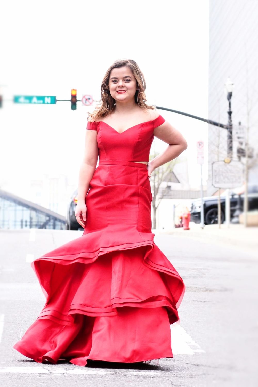 Red prom dress in urban downtown streets