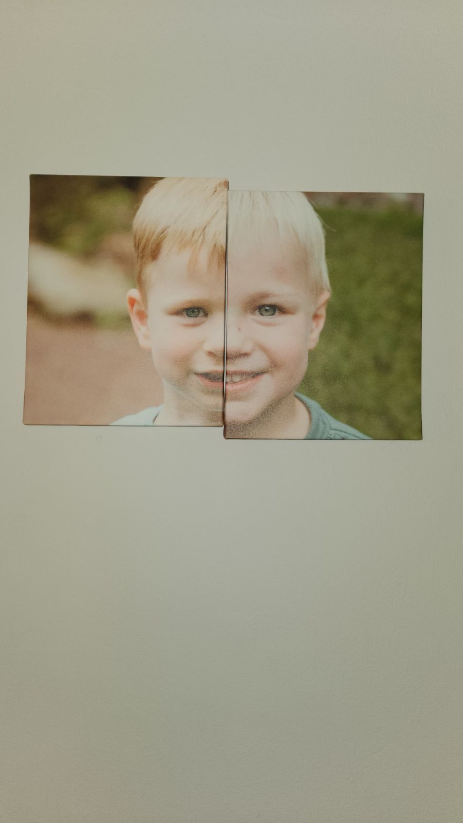 Young child with bright blue eyes and blonde hair in close-up portrait.