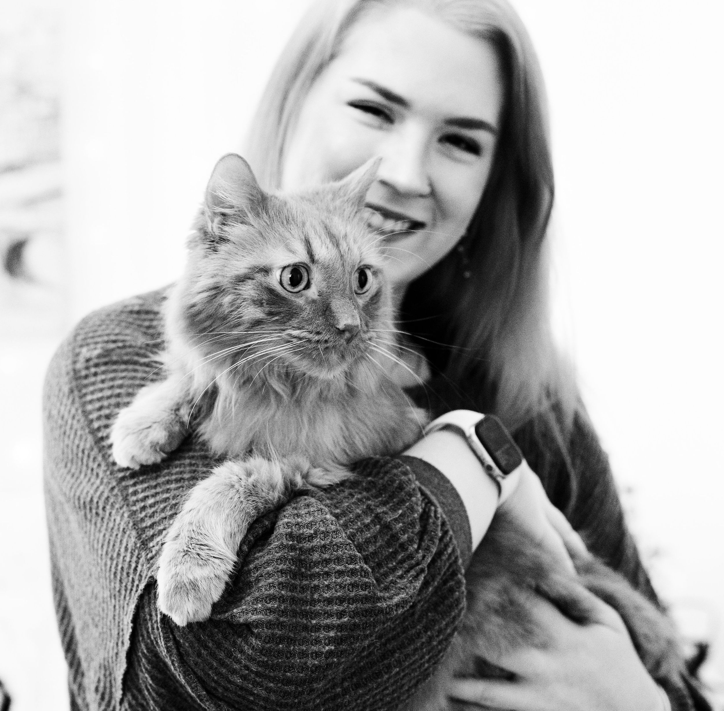 portrait of a young adult and her senior foster hospice cat