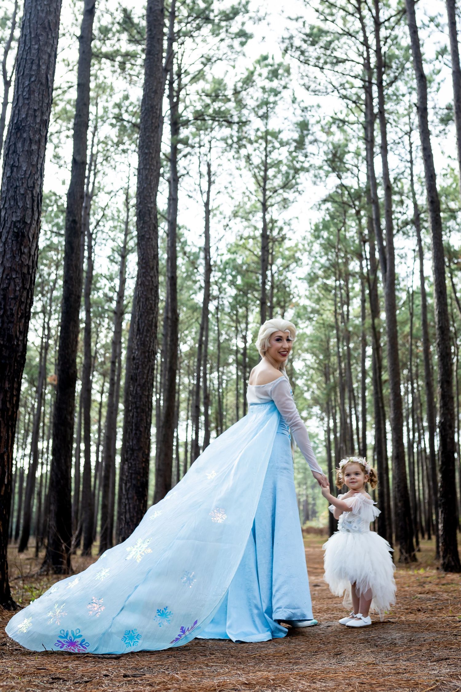 Magical forest scene with flowing blue princess gown and white tulle dress.