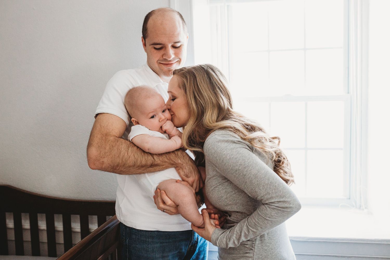 A heartwarming family portrait captures intimate moments with a newborn.