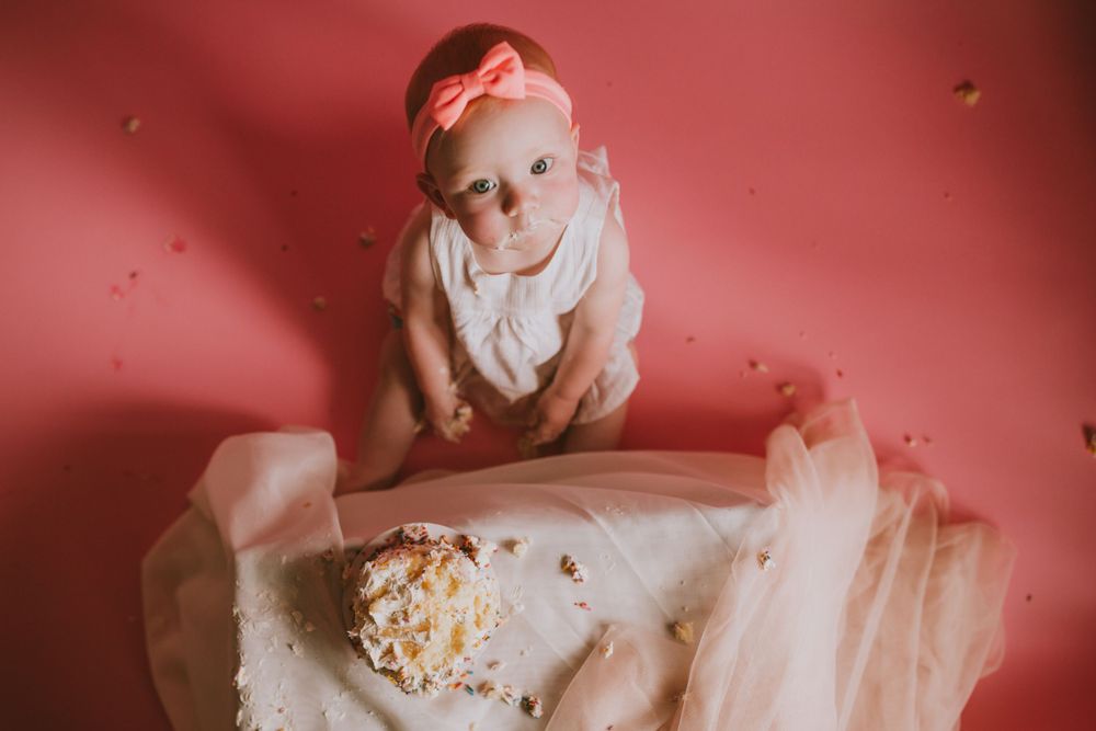 Newborn baby adorned with a pink bow