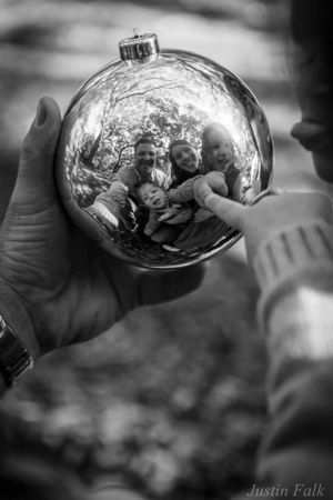 Family reflection in glass ornament black and white