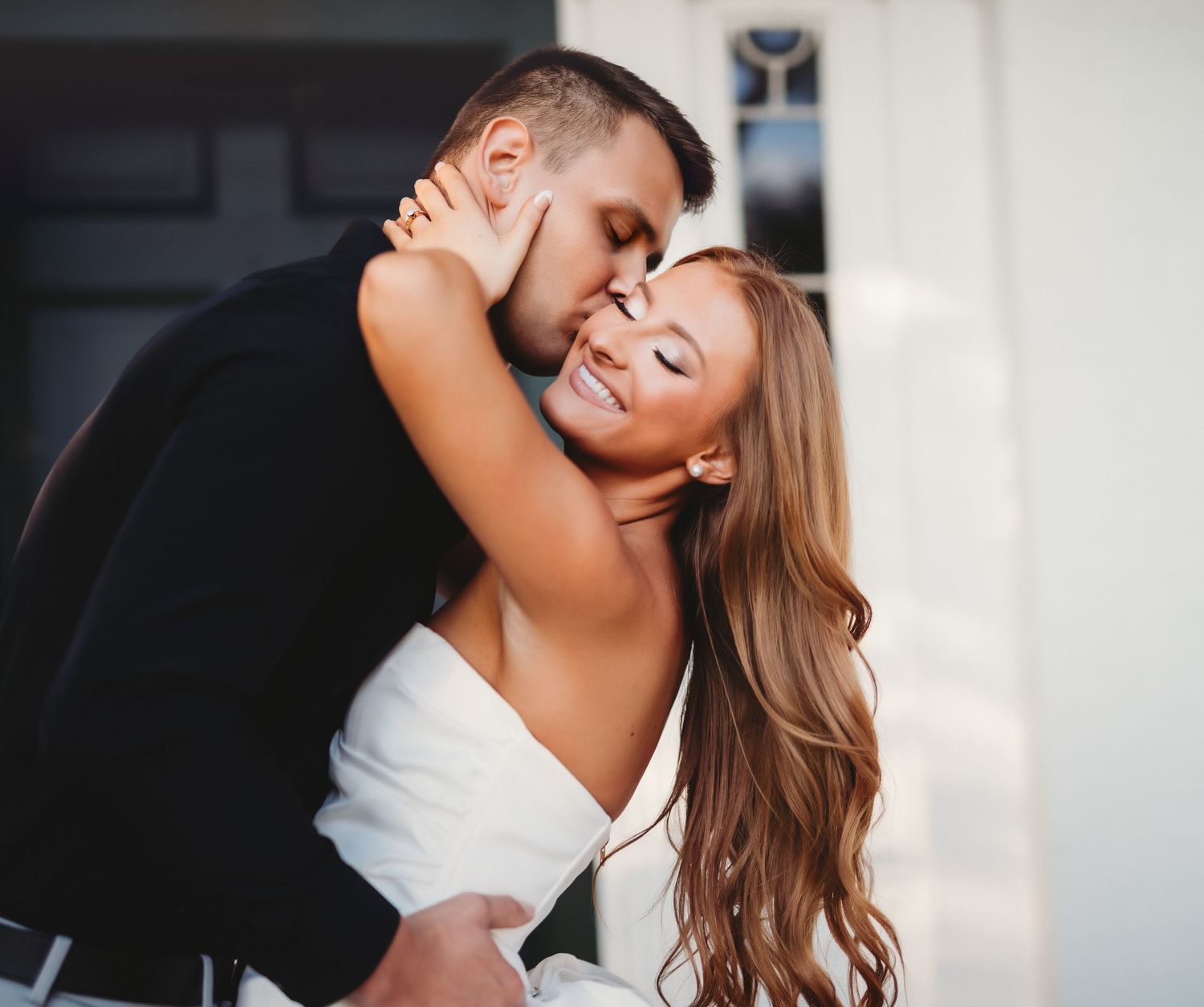 A romantic embrace between a newly engaged couple sharing an intimate moment.
