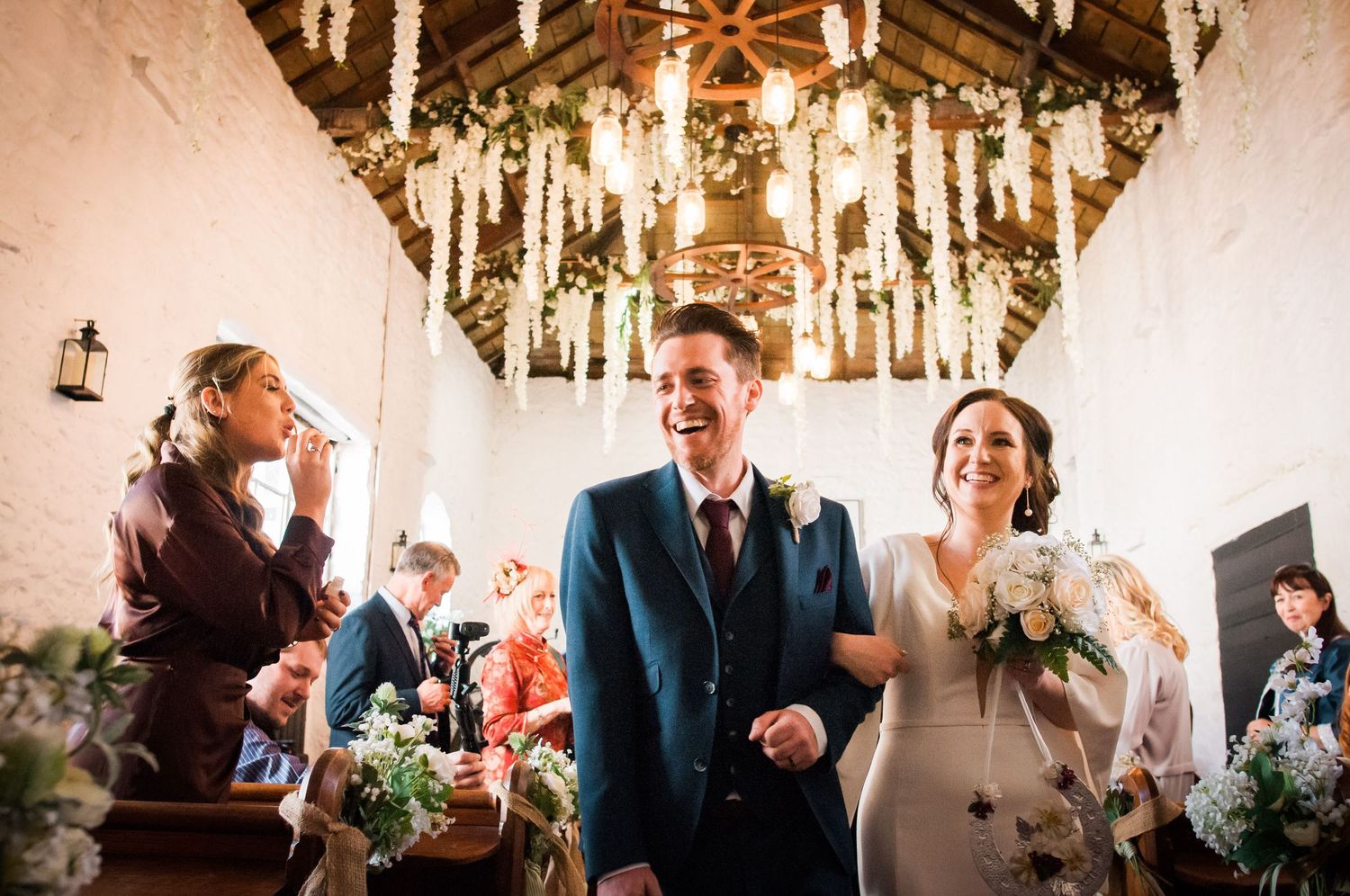Couple walking up the aisle smiling after their Gretna Green elopement.