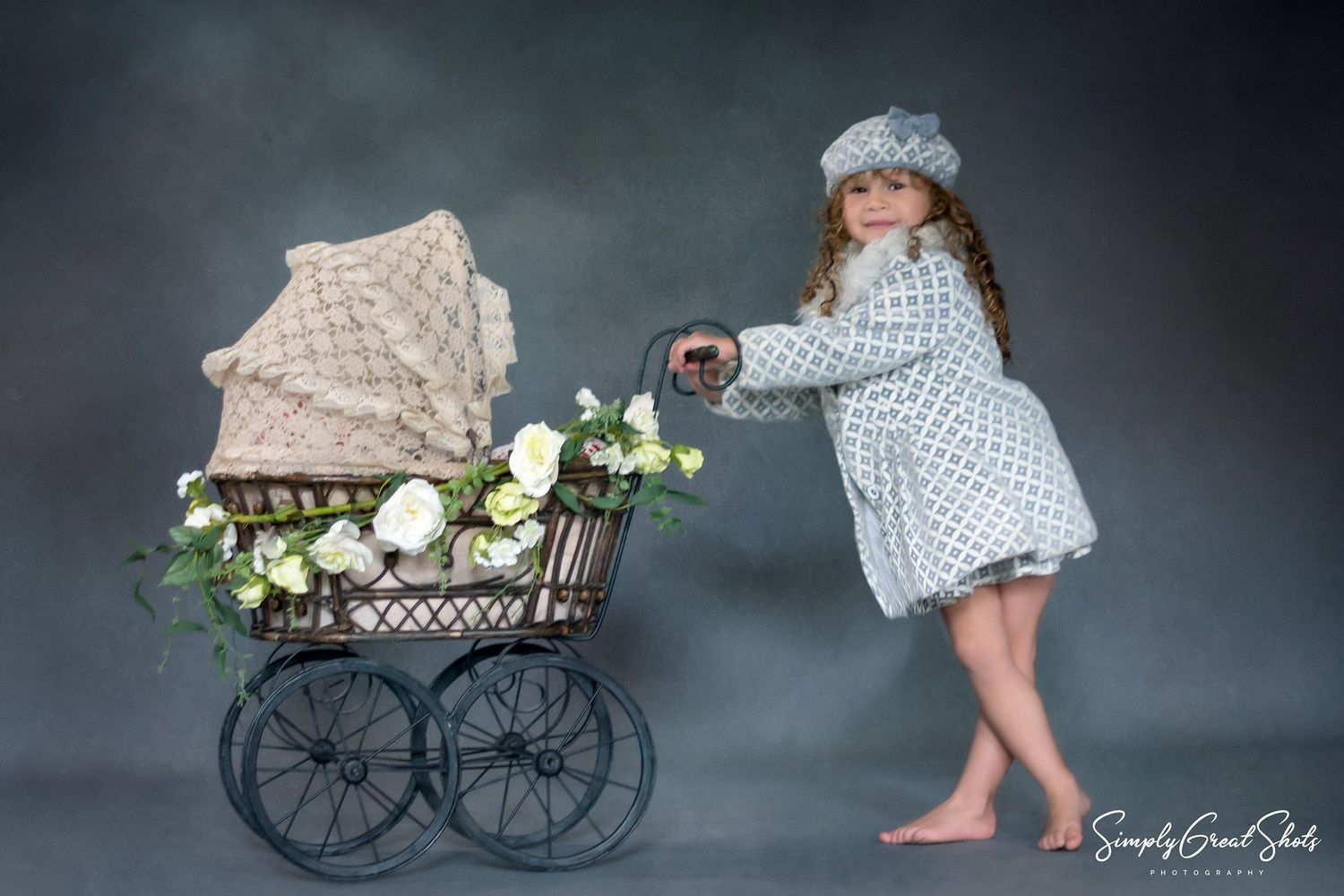 Studio Portrait Photography - A little girl pushing a pram
