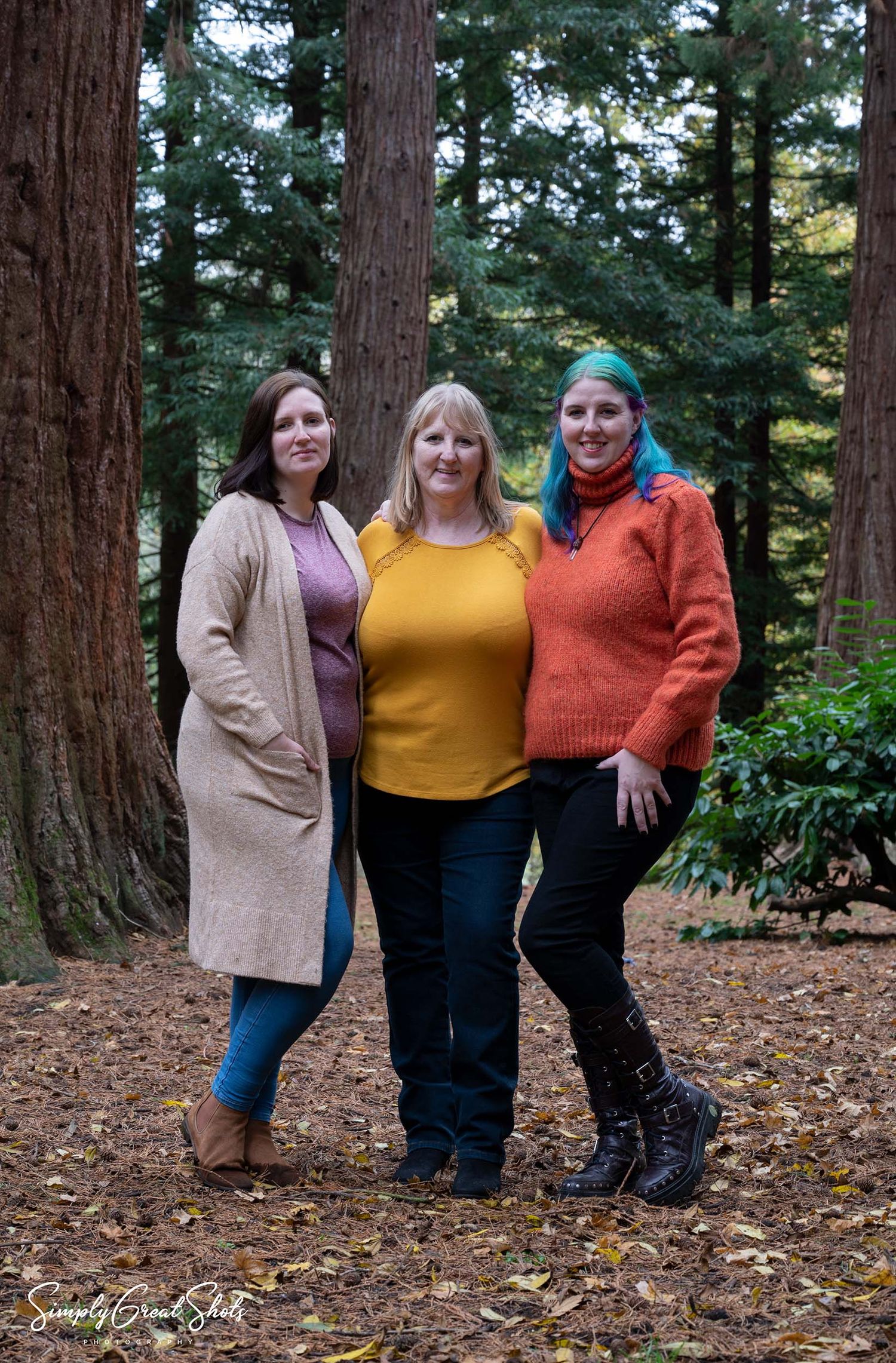 An outdoor family portrait of a mother and her two daughters