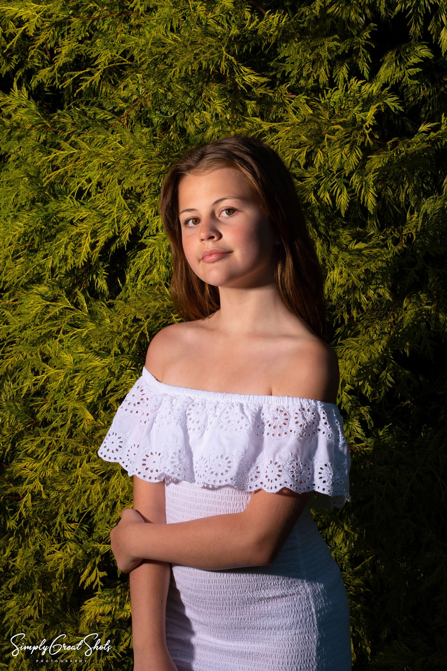 A young lady posing for the camera in a white dress - Portrait photographer