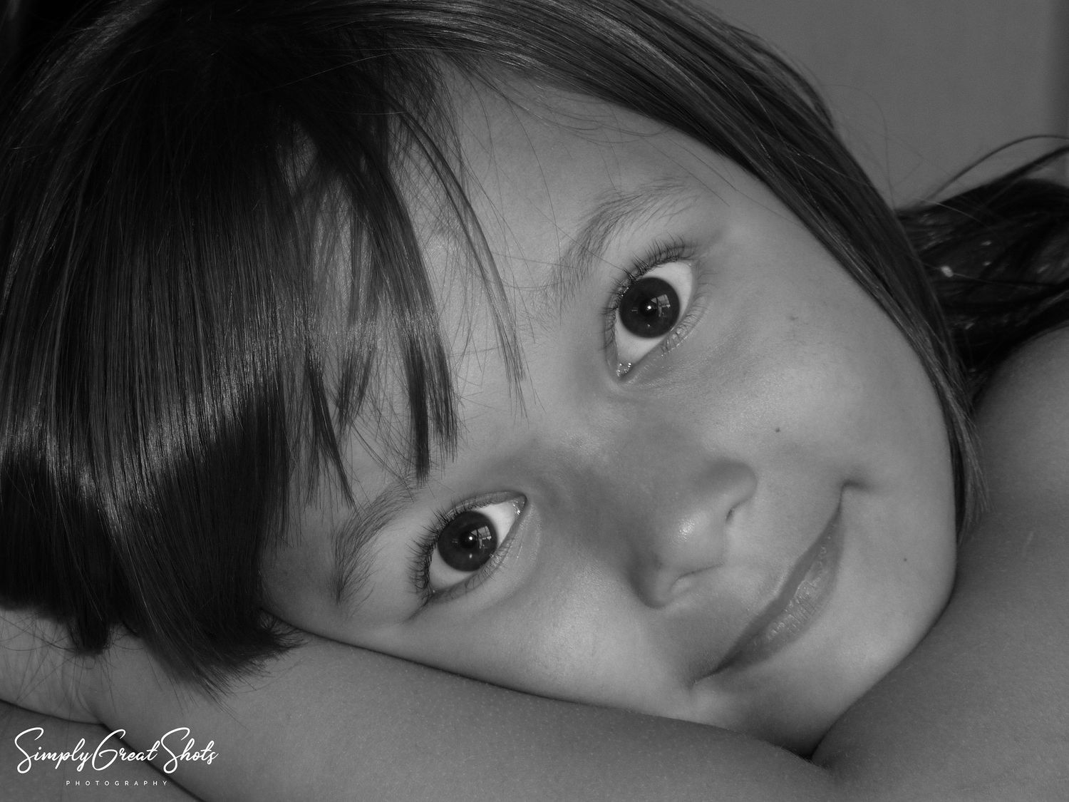 A close up portrait photograph of a little girl