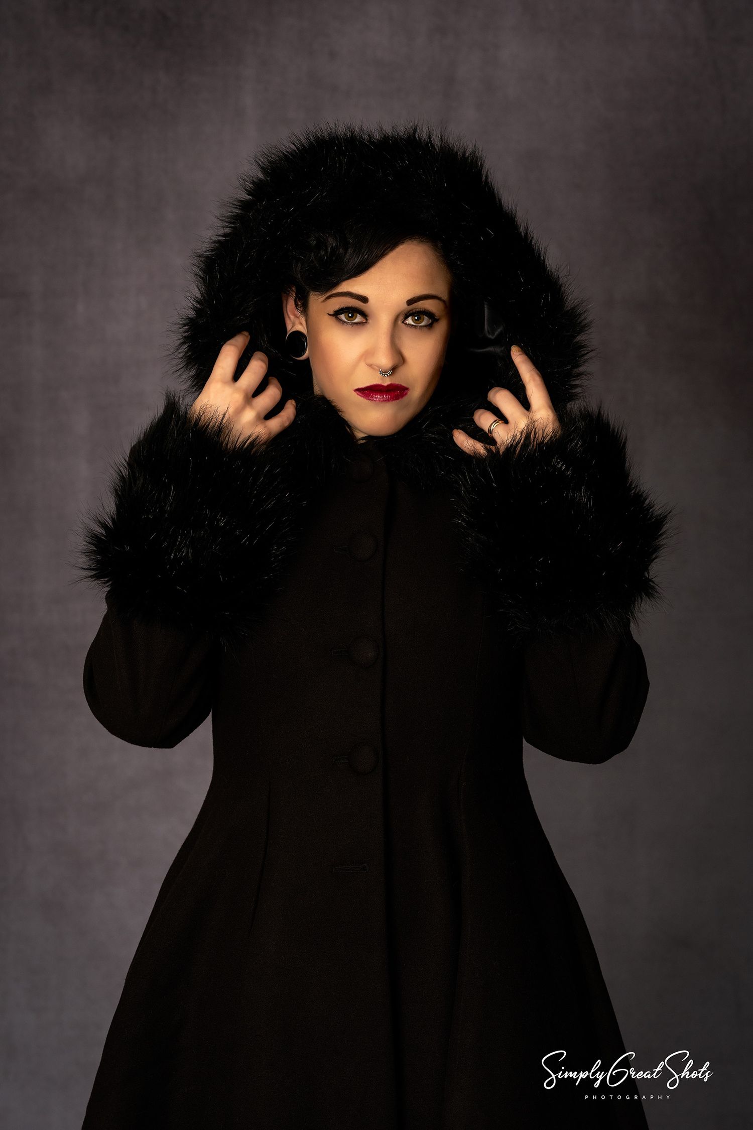 Portrait Photographer - A lady in a black winter coat poses for the camera