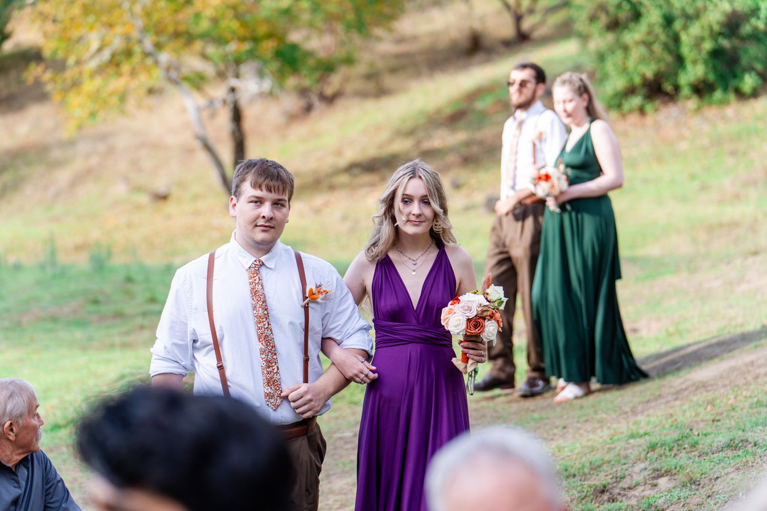 groomsman and bridesmaid in purple