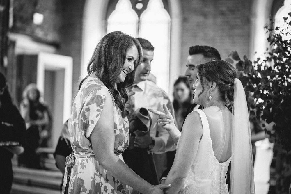 Guests chatting and mingling during an elegant indoor wedding reception.