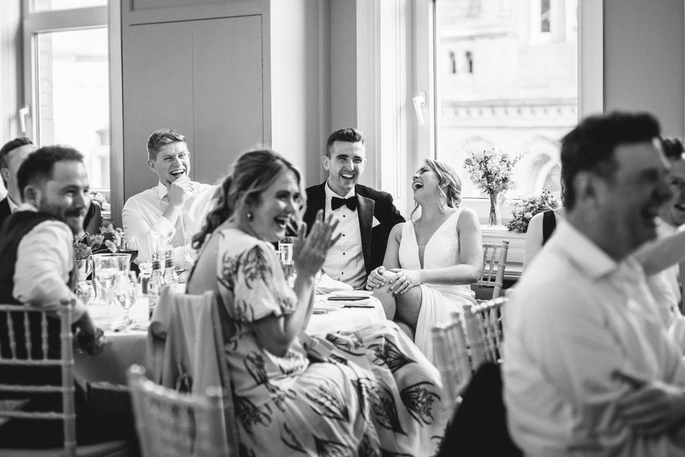 Wedding guests enjoying candid moments during reception celebration.