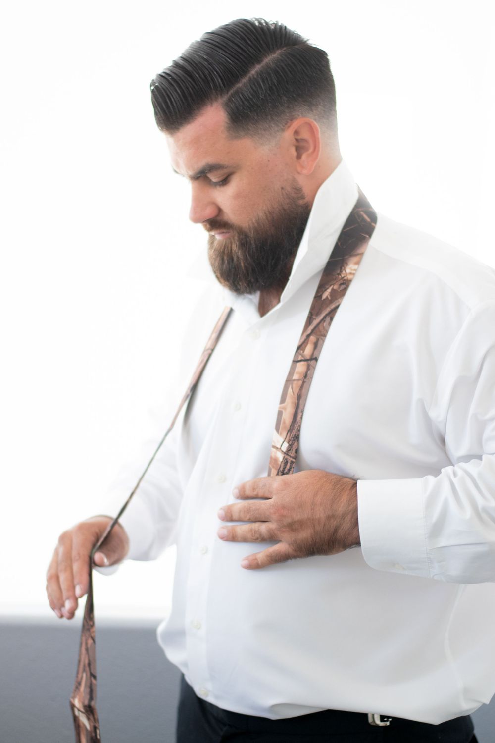 groom getting ready with tie pose
