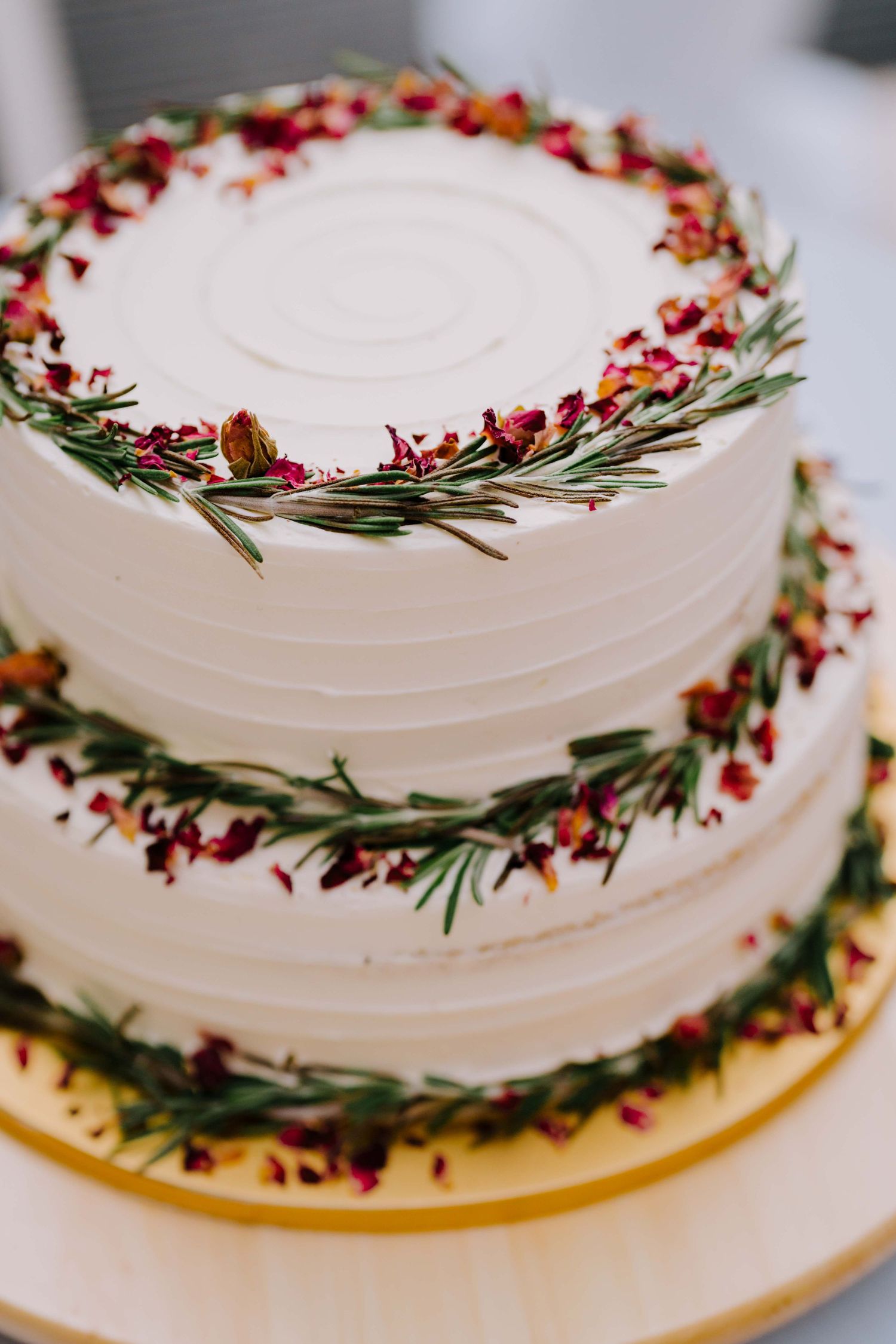 three-tiered wedding cake singapore decorated with rosemary and flowers