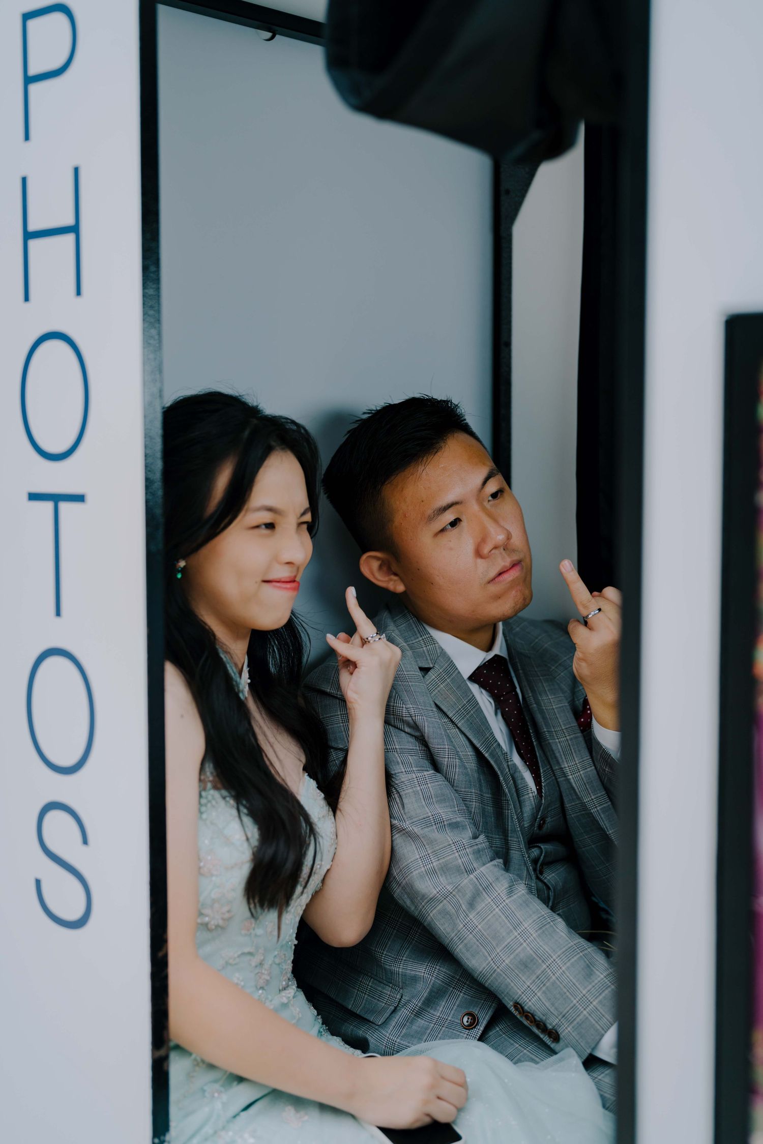 couple poses in a photobooth